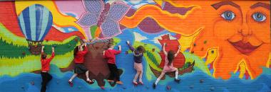 children on multi coloured wall